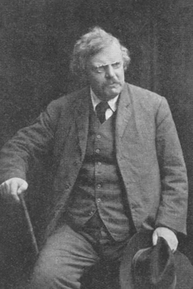 Photograph of G. K. Chesterton seated with a walking stick