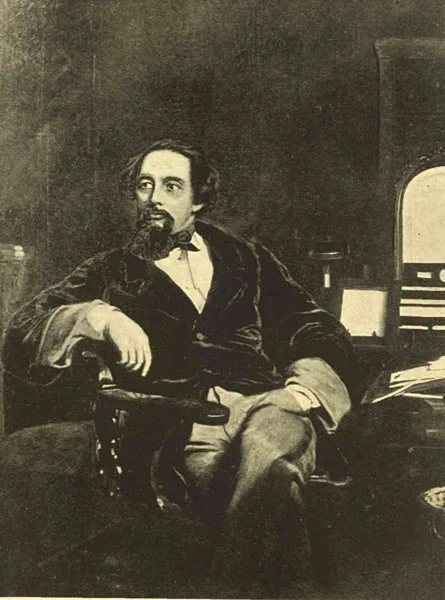 Photograph of Charles Dickens seated at a writing desk